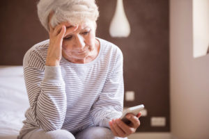 Senior woman frustrated with cell phone technology